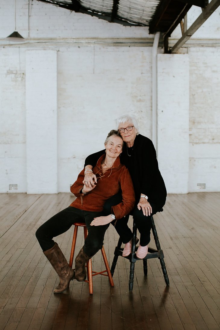 Gail + Liz. Been together for 27 years, not legally allowed to marry in Australia. “The first time I saw her the room literally stood still just like in the movies!” muses Liz. “We paint and play music together. I value the ways we are both willing to work at being in relationship” says Gail.