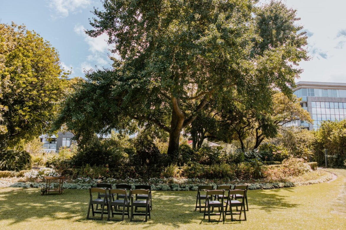 A wedding ceremony setup with chairs is in the gardens of Highwic in Newmarket - Central Auckland.
