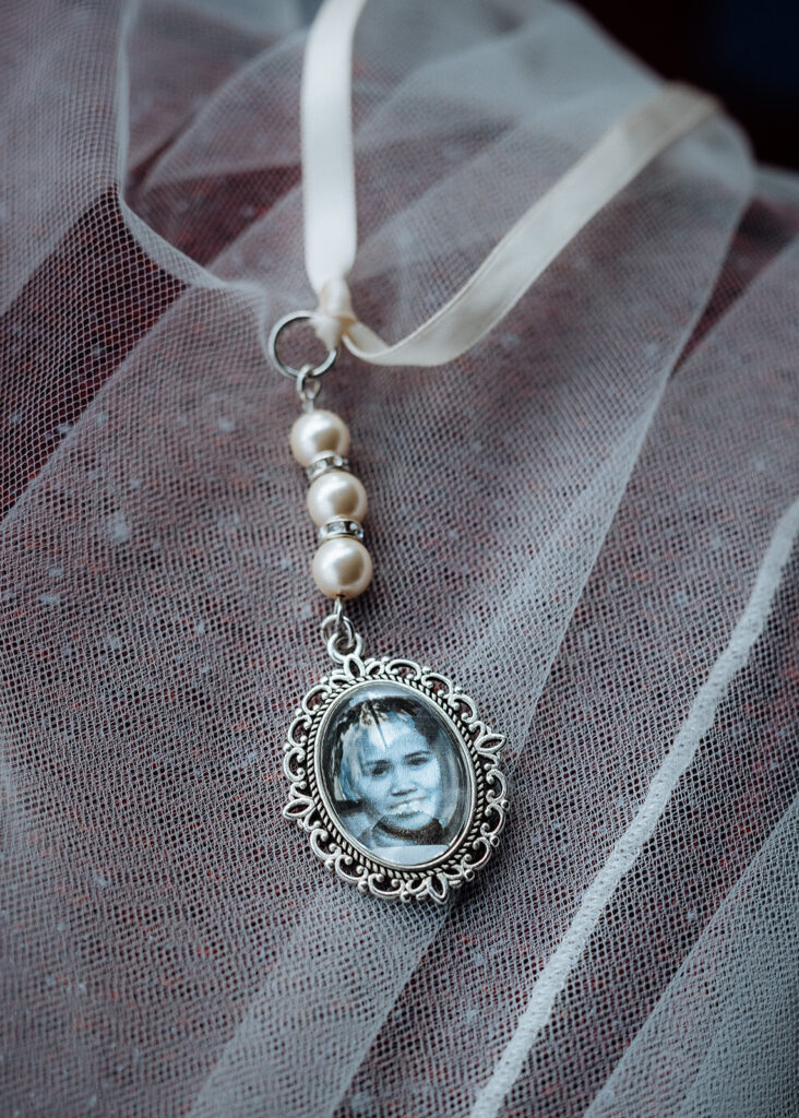 A photo of a family member is in a locket to he held by the bride on her wedding day