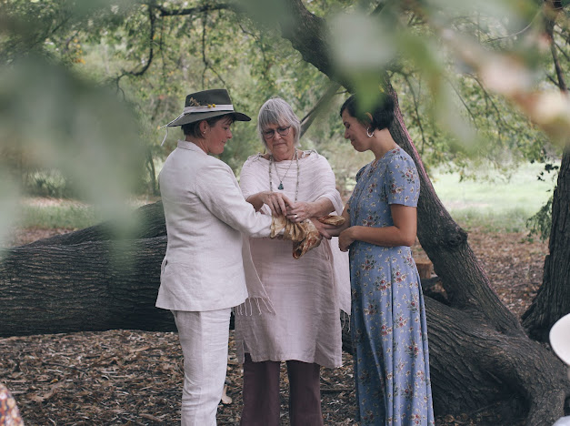 A handfasting at a wedding in a community garden in Fitzroy