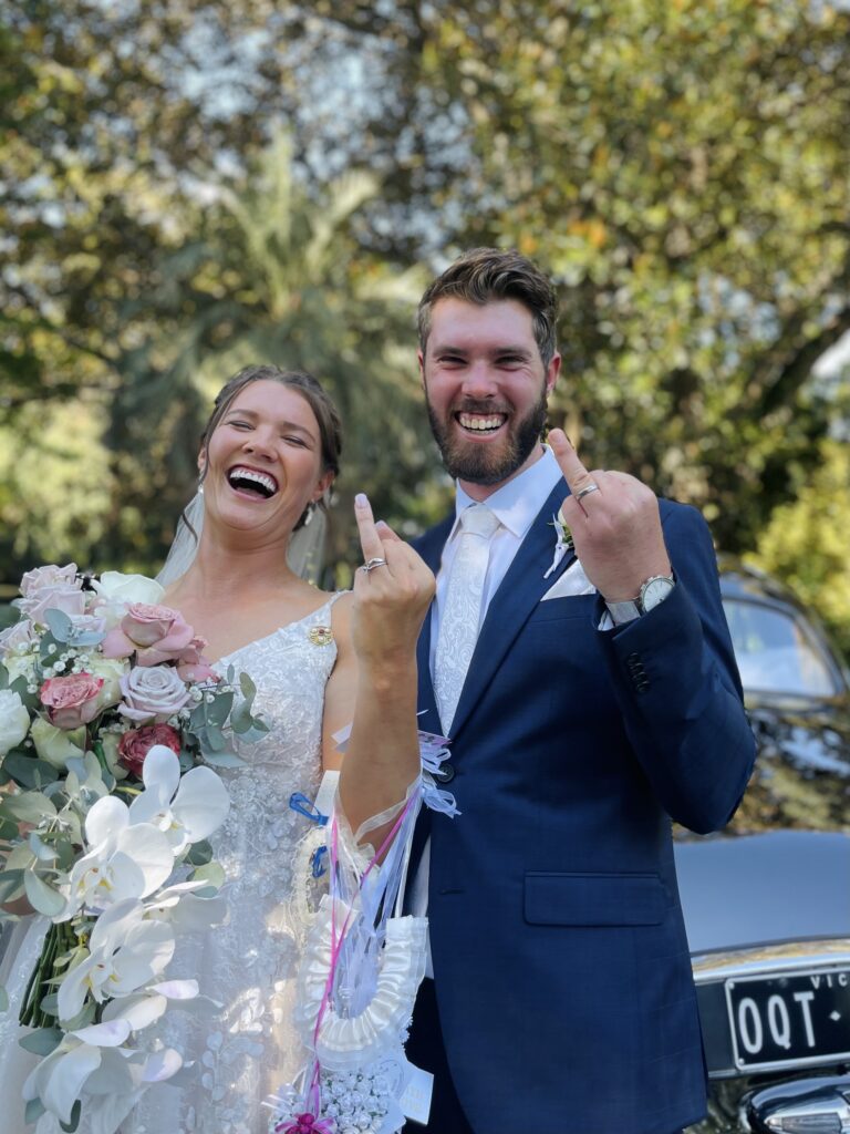 Couple wearing Coral Covey wedding rings