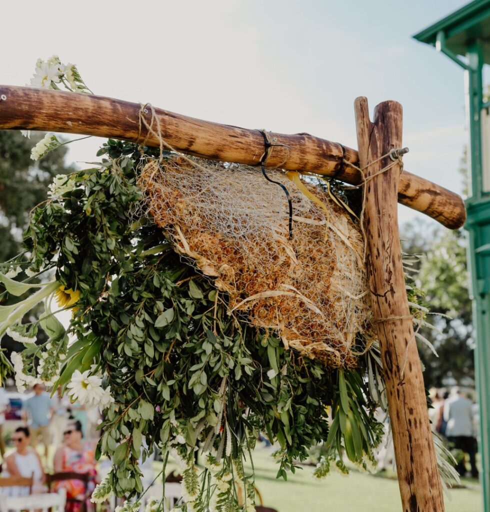 AgraWool's Sideau sustainable floral foam alternative is held together with chicken wire to create this arbor piece